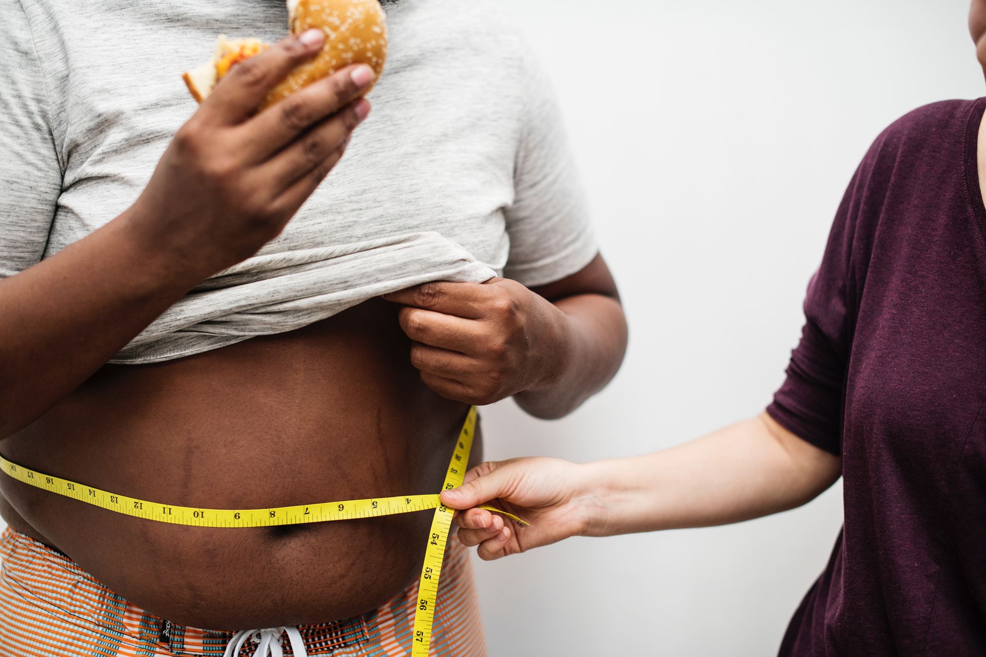 a man having his waist measured